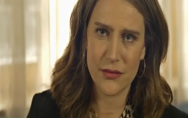 Worried woman by a child's hospital bed.